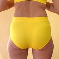 crop of model wearing yellow marigold mid rise briefs