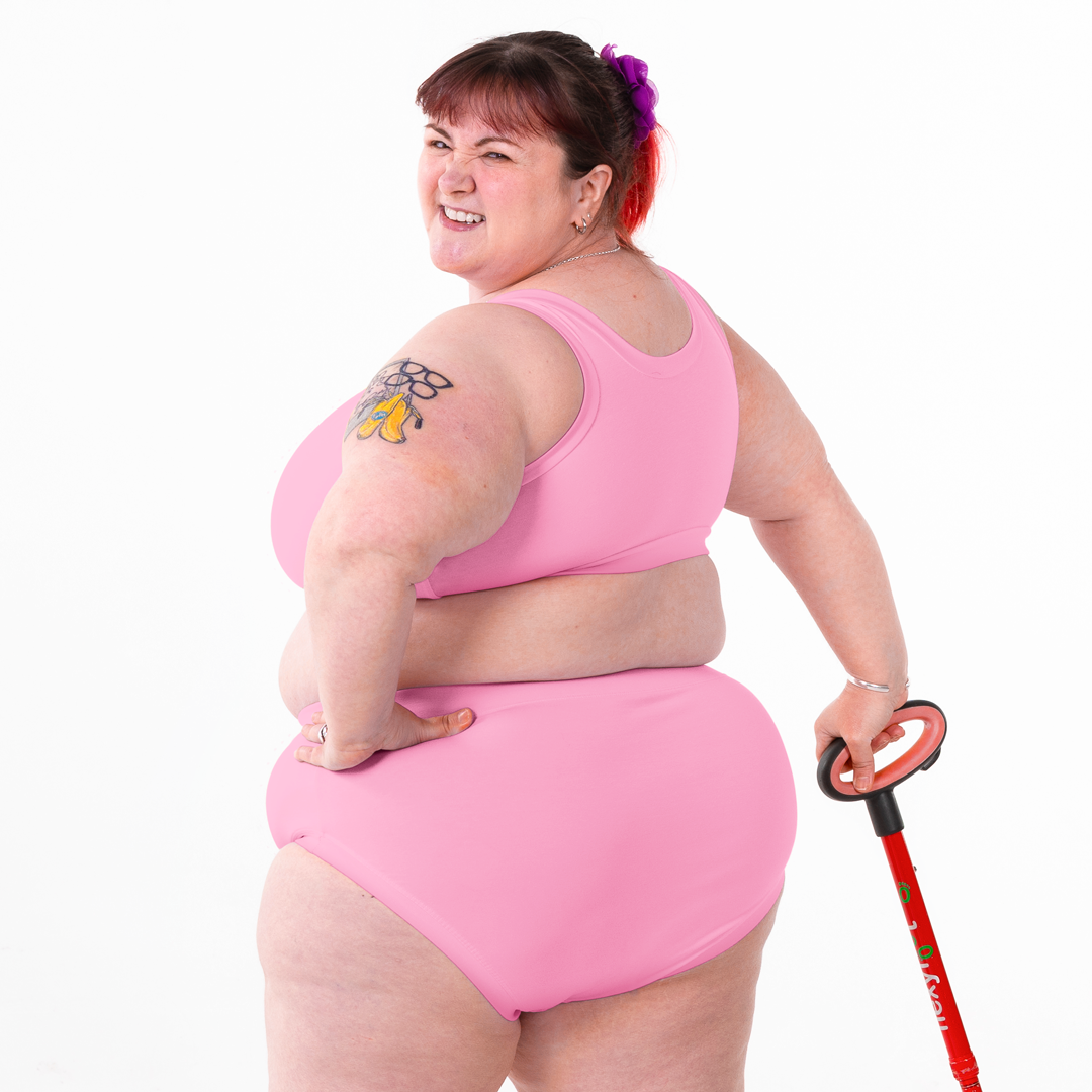 Back view of Rhona wearing a pull on pastel pink bra and high rise cotton briefs