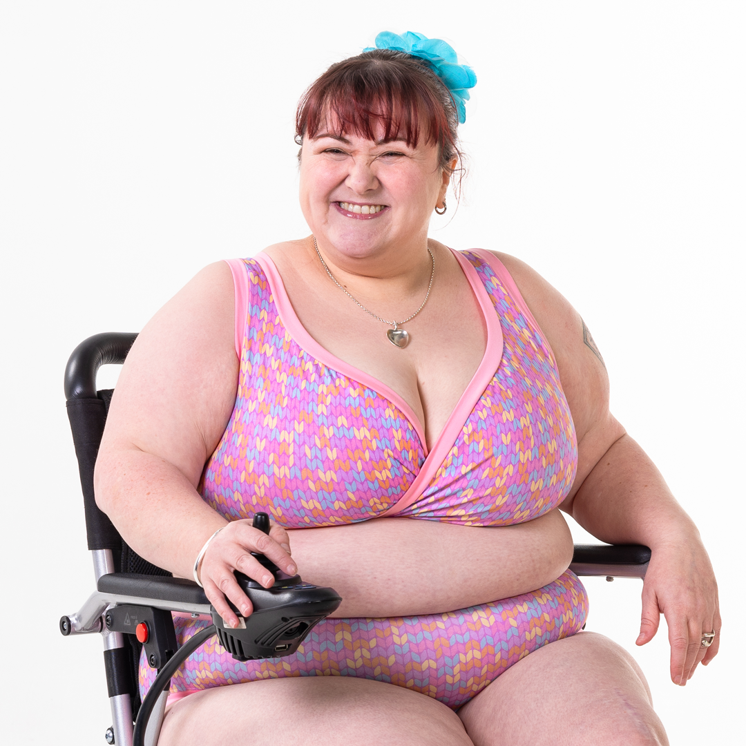Rhona is sitting in her wheelchair wearing a Candy Knit underwear set