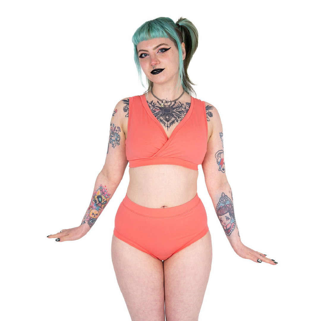 Faeryn wearing a coral non wired bra and high rise briefs