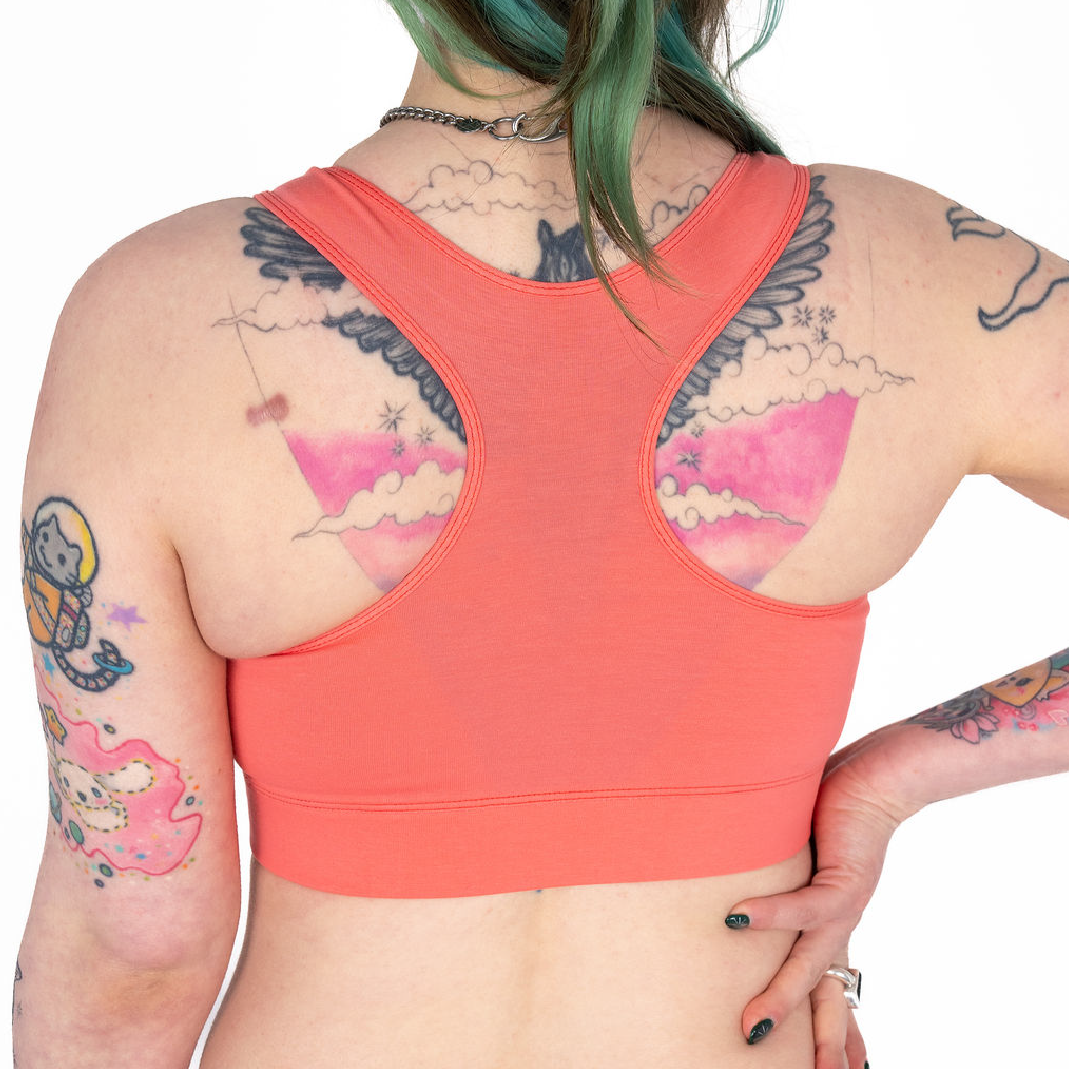 Back view of Faeryn wearing a coral racerback bralette