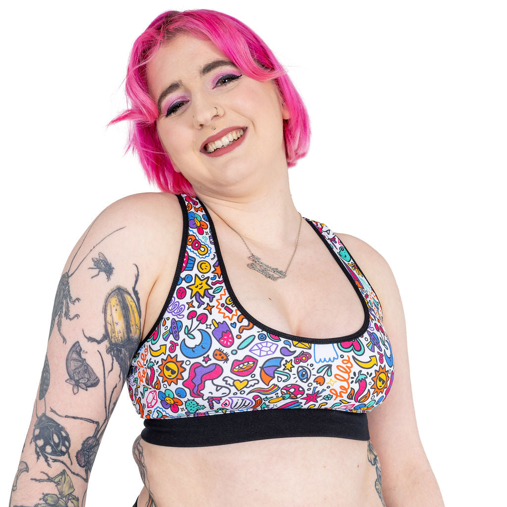 Elia smiling wearing a cotton racerback bralette in doodles