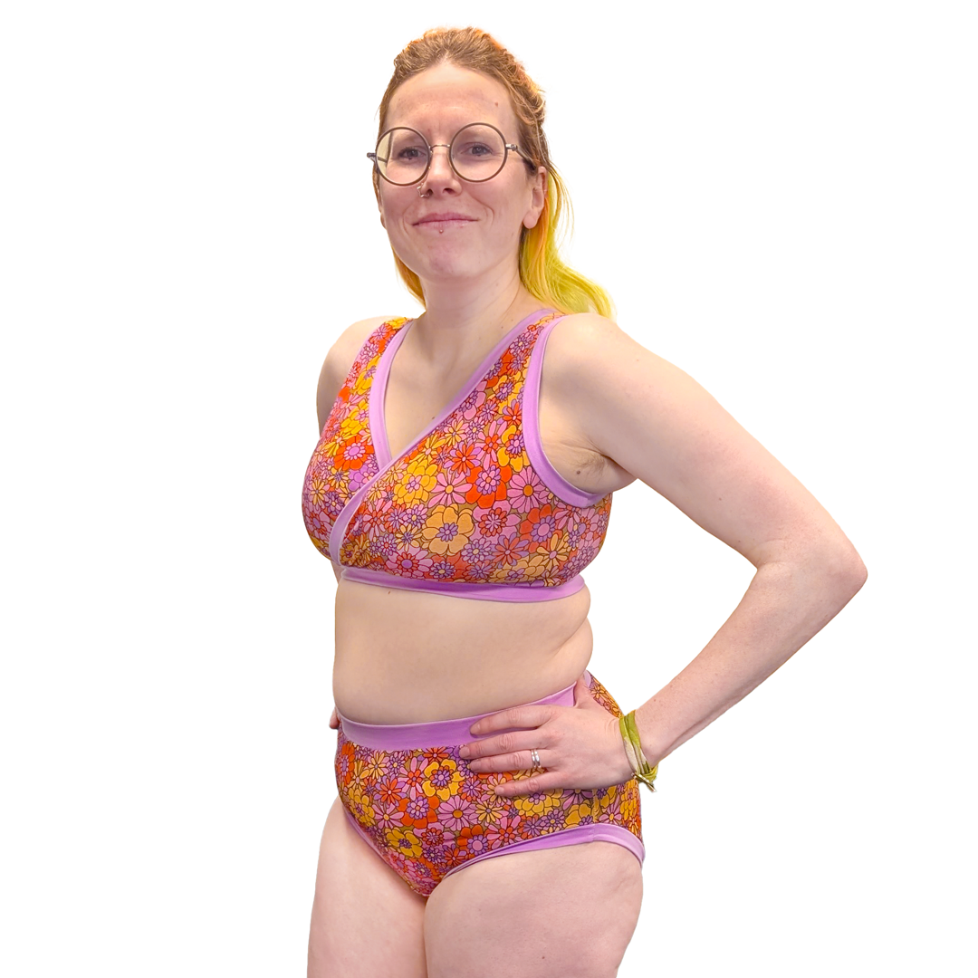 Jen is side on to camera wearing a crossover style bra and briefs in Flora print.