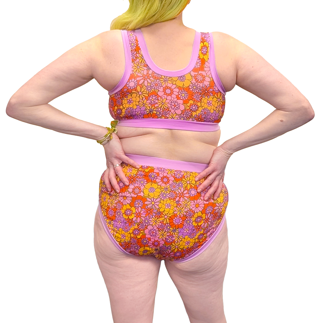 Jen has her back to camera and is wearing Original bra and high rise briefs in Flora.