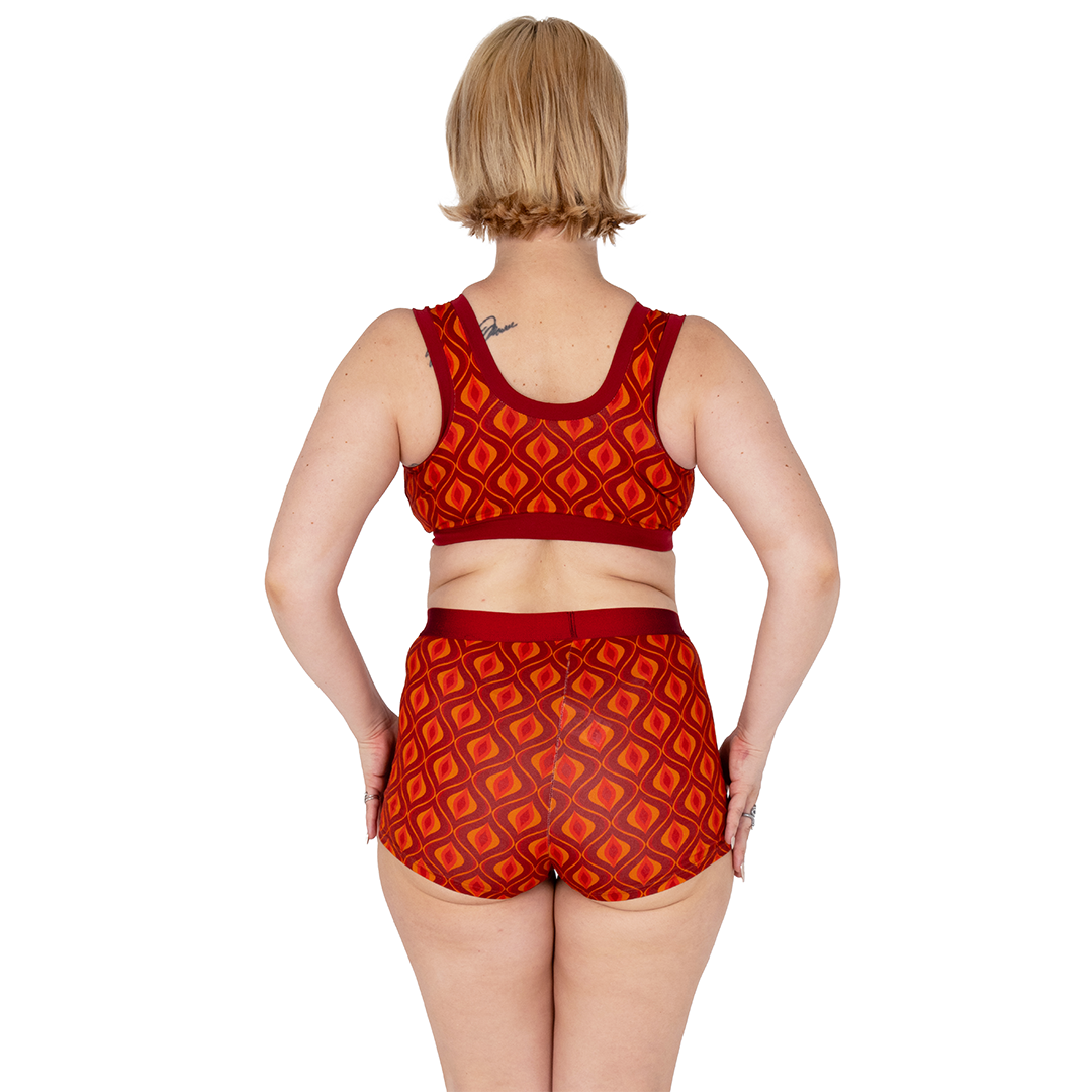 Back view of Ola wearing a non wired pull on bra and boxer briefs in Groovy design