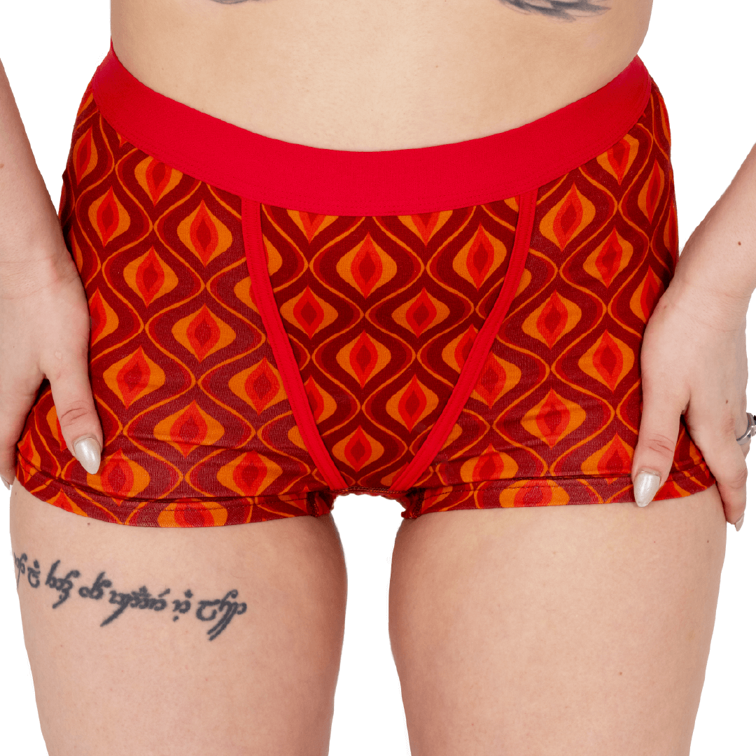 Model is wearing a pair of cotton boxers briefs in a retro Red Groovy pattern