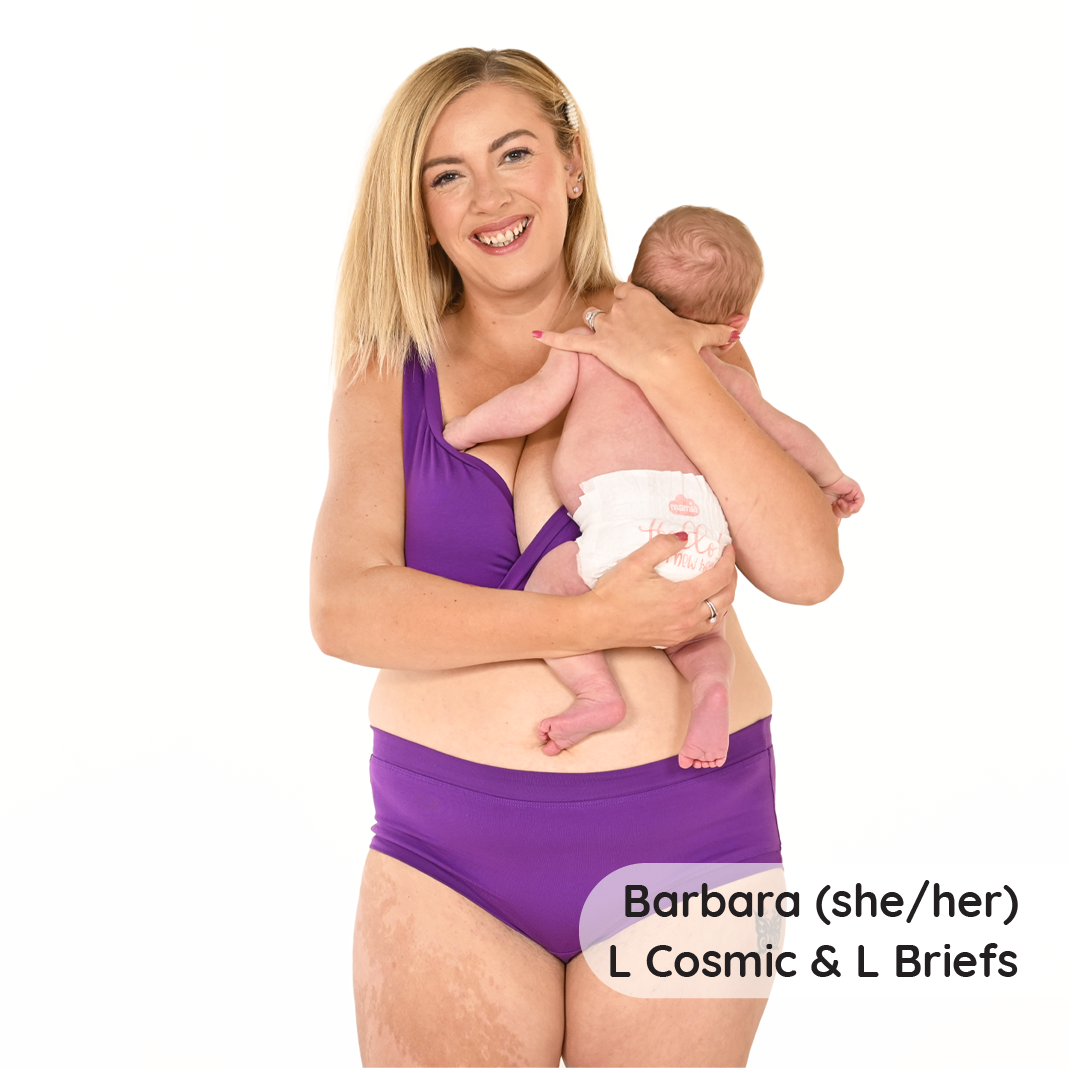 Barbara is wearing an Iris underwear set holding her baby
