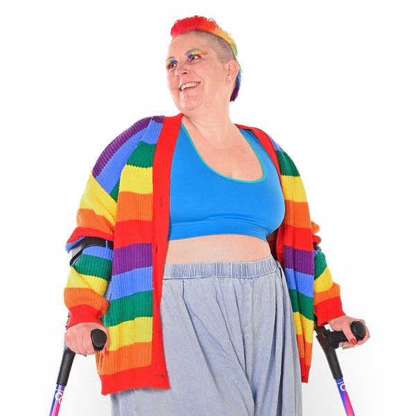 Kirsty is wearing a lagoon bralette, trousers and a rainbow cardigan