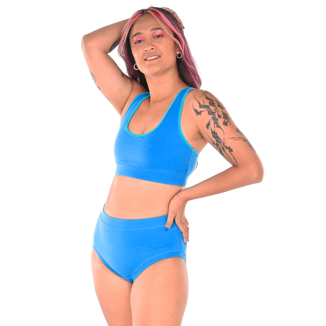 Sarah is wearing a lagoon racerback bralette and high rise briefs