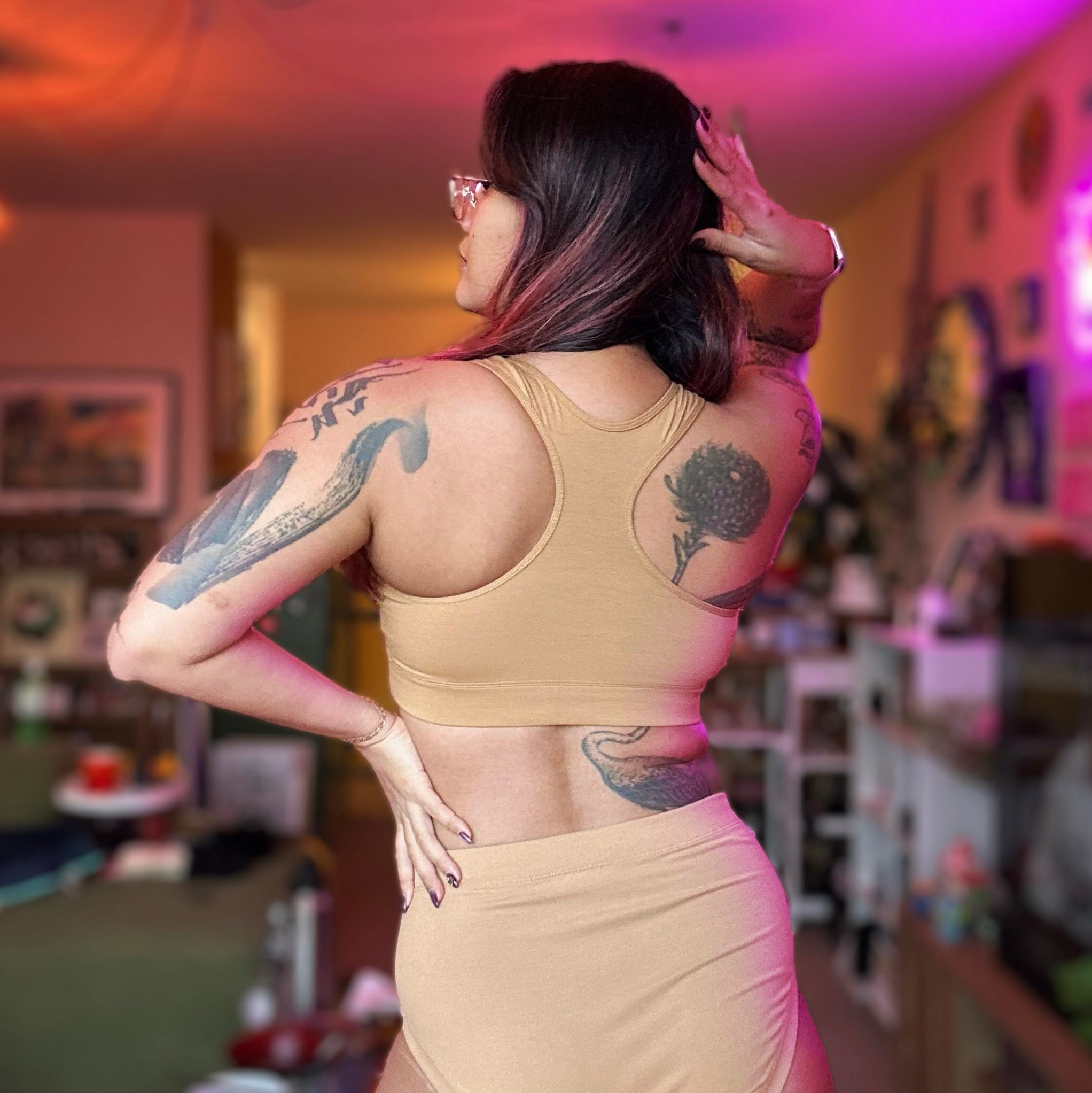 back view of Sarah posing in a nude racerback bralette and briefs