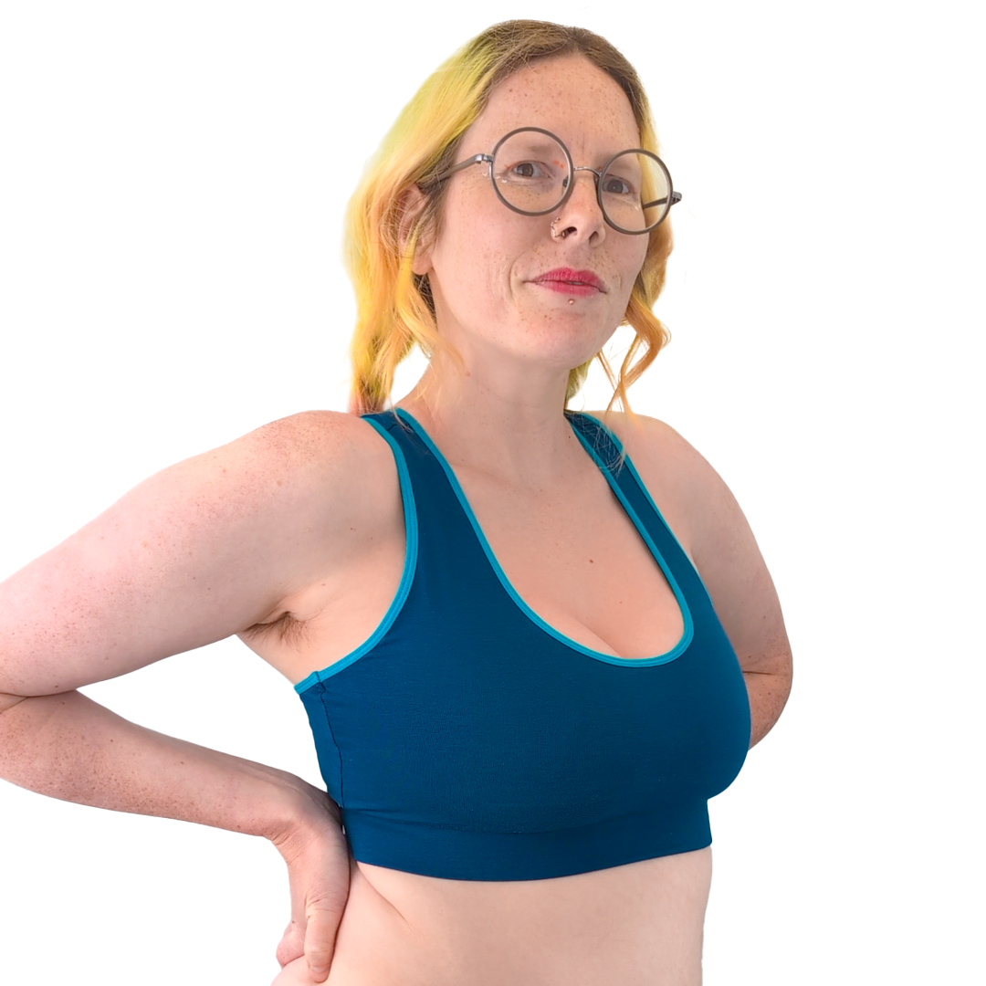 Jen wearing a Petrol Blue cotton bralette in the scoop neck Mighty style. It has lagoon blue piping around the arms and neck. 