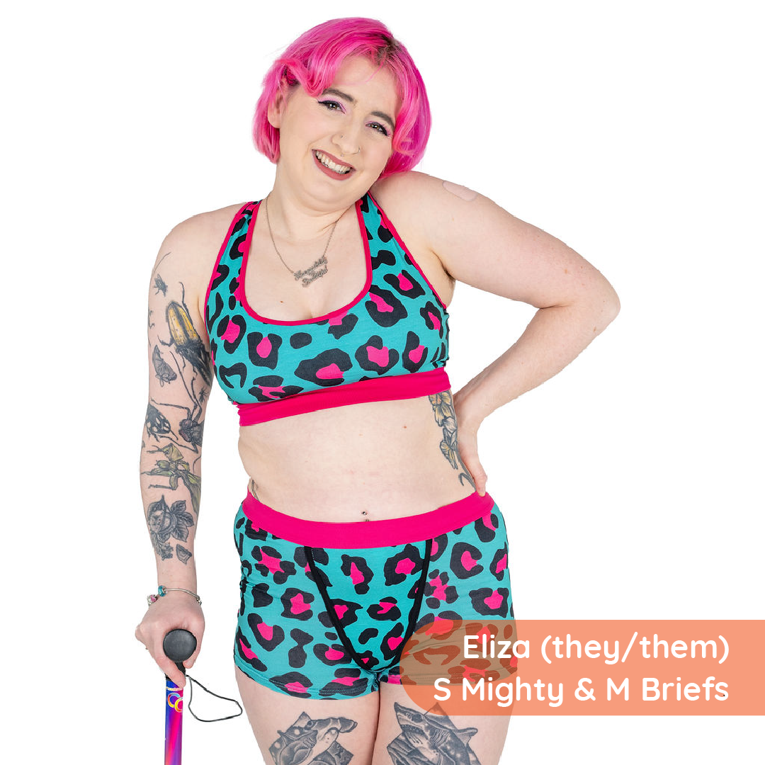 Person wearing a colorful leopard print sports bra and shorts set on a white background