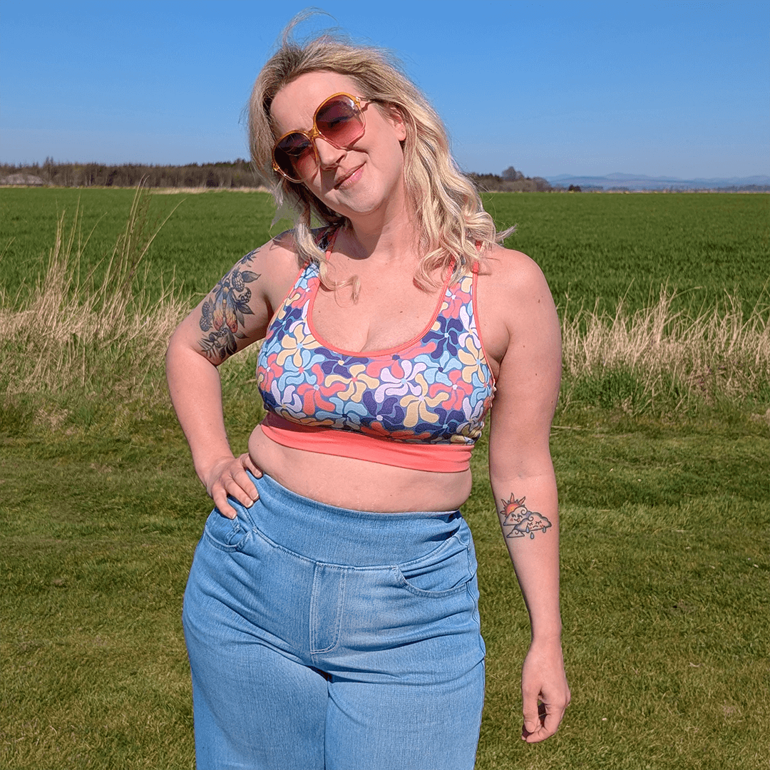 Ros is outside in the sunshine wearing a Wavy Flowers bralette and jeans