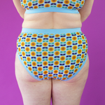 Cropped view of Katy wearing high rise sunflower print briefs