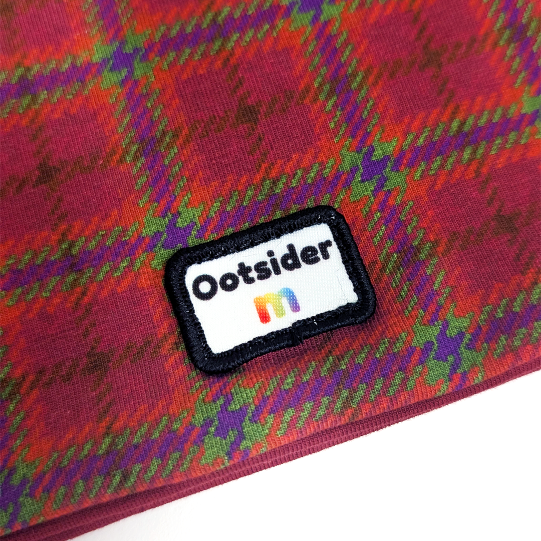 Close up of tartan hat with Ootsider and Molke label