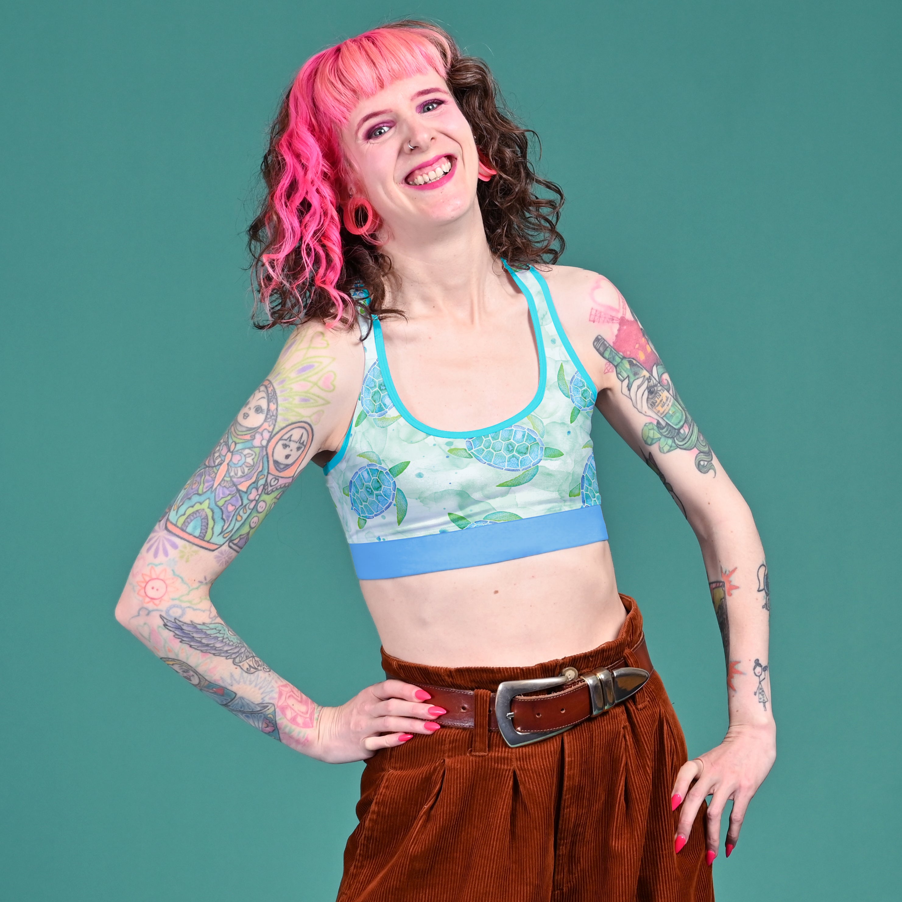 Tracy smiling and wearing a Mighty cotton racerback bralette in Turtles print.