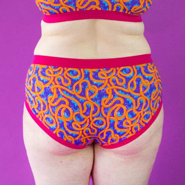 Close crop of Katy wearing mid rise colourful cotton briefs in wiggles design