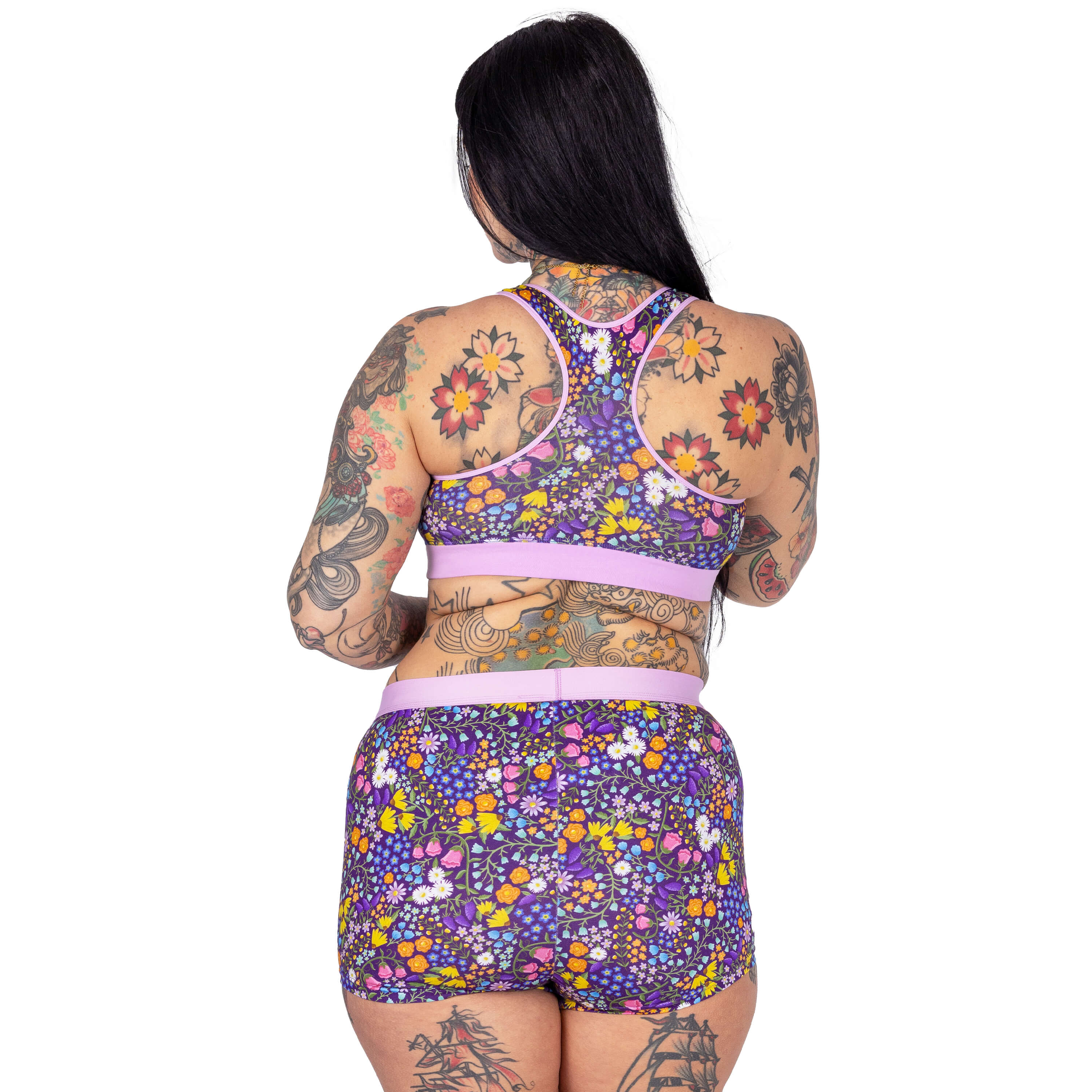 Back view of Aimee wearing a racerback bralette and boxers in Wildflowers