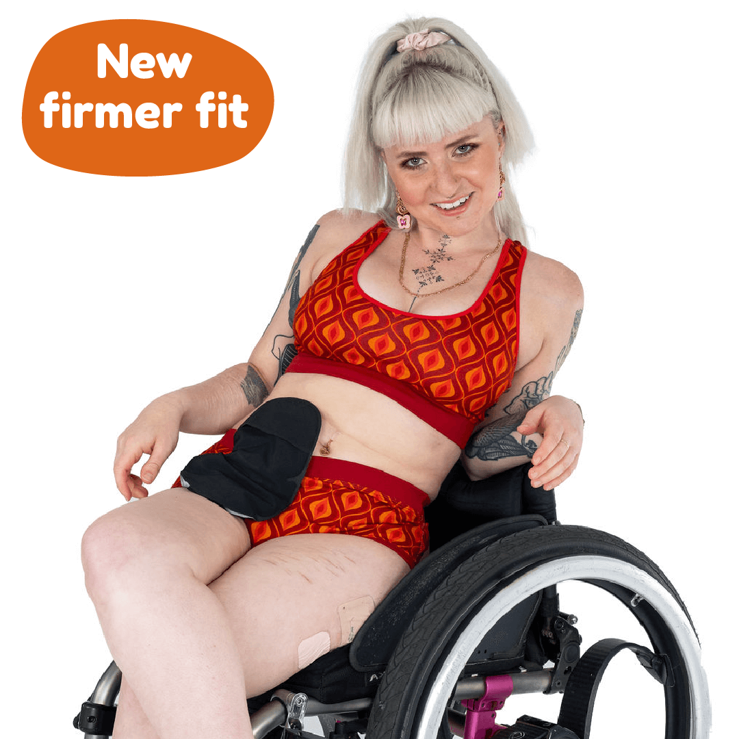 Jess is in her wheelchair wearing a Groovy bralette and briefs