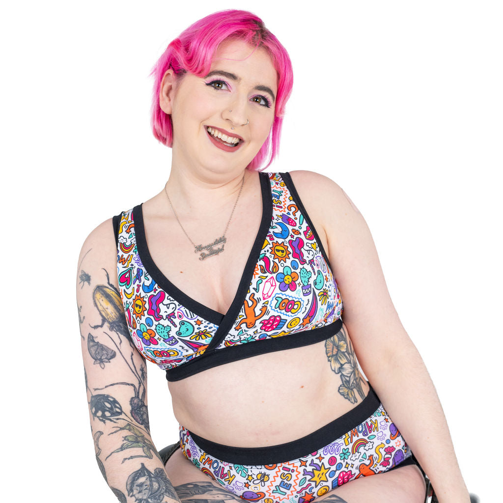 Eliza sitting wearing a Doodles bra and high rise cotton briefs