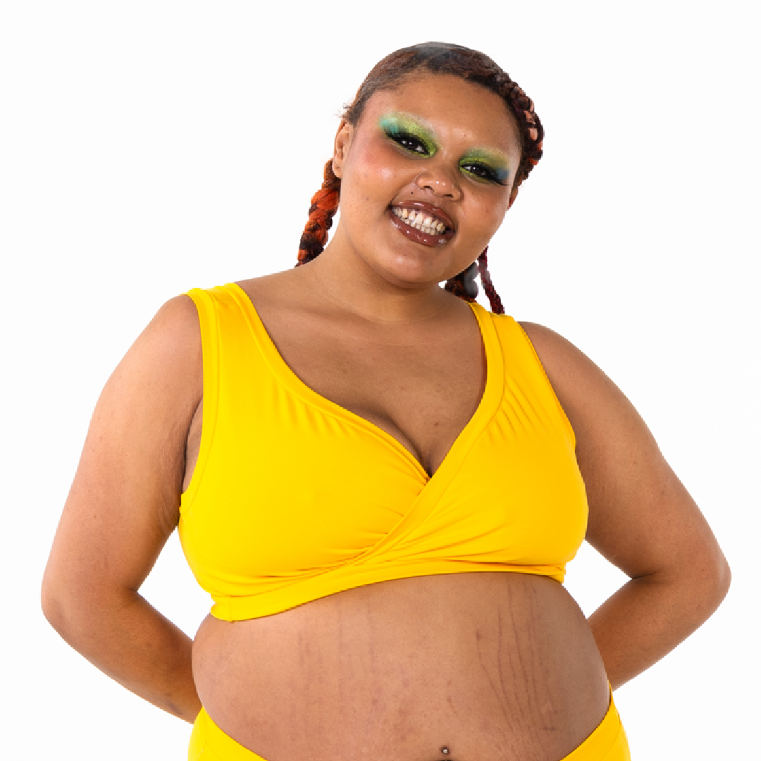 Kathryn is smiling wearing a yellow non-wired bra