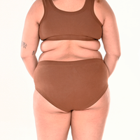 Back view of Tumi wearing mid rise skin tone brown underwear
