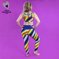 Back view of Ros wearing rainbow pride leggings and bra