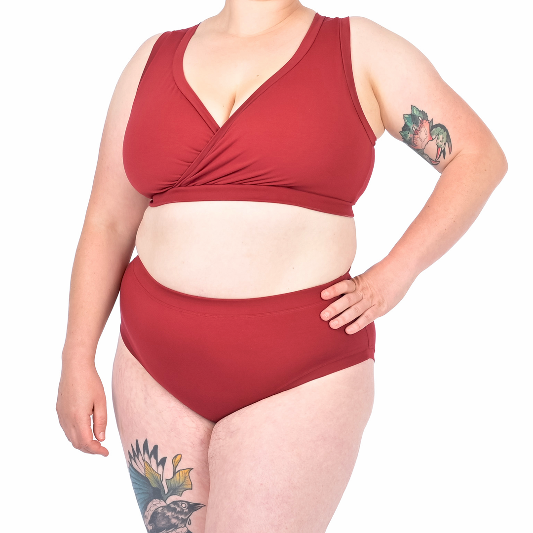 Cropped image of Katy wearing maroon high rise briefs and non wired bra