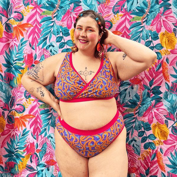 Georgia is wearing a wiggles underwear set against a colourful background