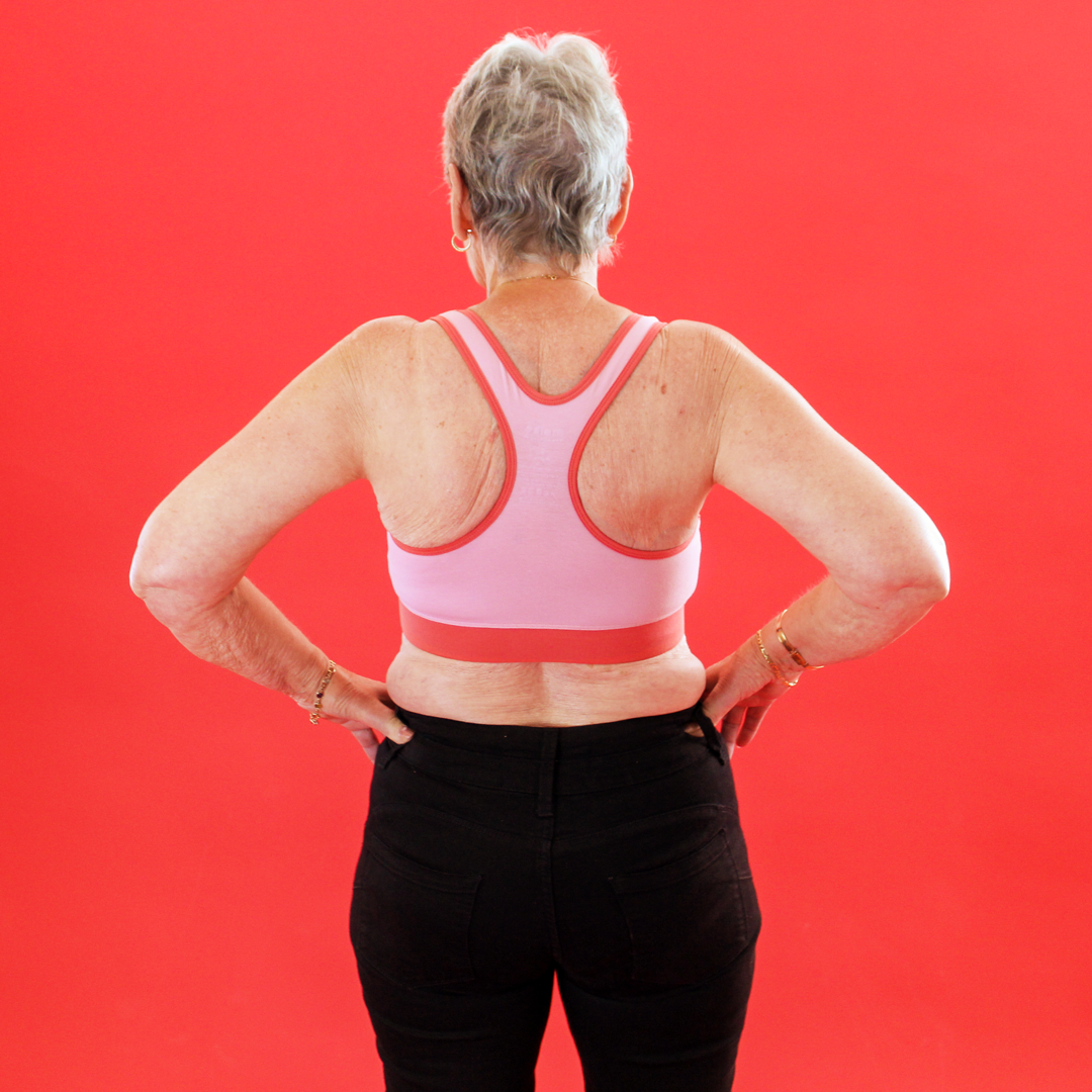 Back view of Norma wearing a candyfloss pink racerback bralette