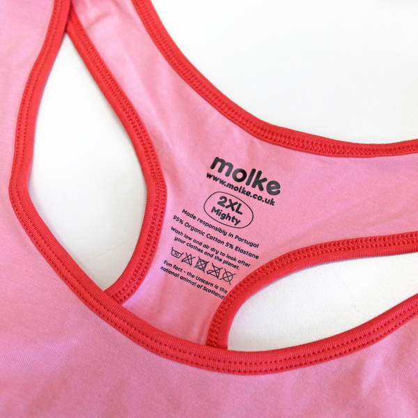 Close up of printed sensory friendly label on candyfloss pink racerback bralette