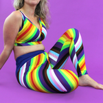 Close up crop of model wearing rainbow striped leggings and bra