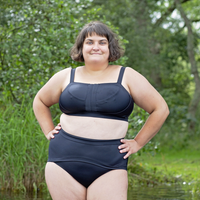 Model is wearing a black bikini with high rise swim briefs