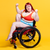 Model is wearing a non wired Power underwear set. She is sitting in a wheelchair and making a strength pose with her arms.
