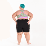 Back view of Estelle wearing a racerback fuller bust bralette and black cycling shorts