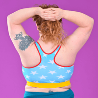 Back view of Lisa wearing a crop top with blue and white stars