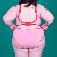 back view of Molly wearing low rise candyfloss briefs and bra