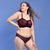 Alice is wearing a cherry red bra and briefs with a black lace pattern and trim