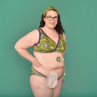 Fiona is standing posing in a dinosaur underwear set and matching tubie pad