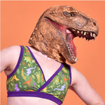 Model is wearing a dinosaur bra and realistic dino mask