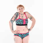 Eilidh is wearing a pink, black and teal non wired bra in leopard print