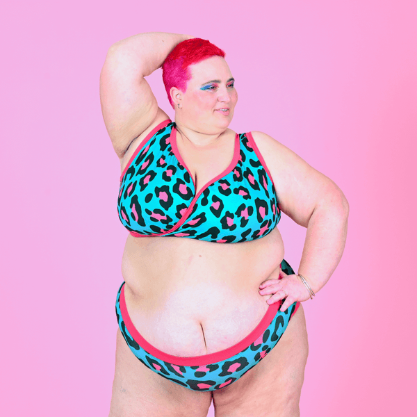 Estelle is wearing a teal and pink leopard print underwear set with high waist briefs