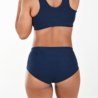 Cropped image of Precious wearing high rise navy briefs and bra