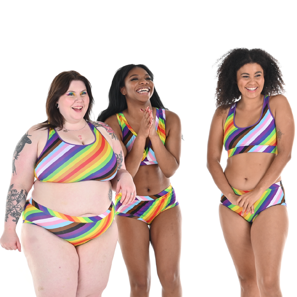 Three people wearing inclusive pride rainbow underwear
