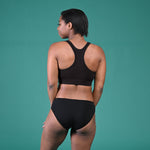 Back view of Precious wearing a racerback croptop and briefs