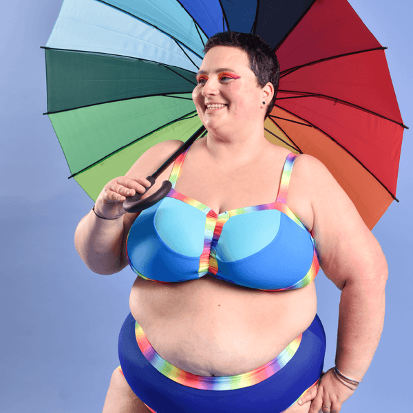 Estelle is wearing a blue rainbow bikini and high rise swim briefs