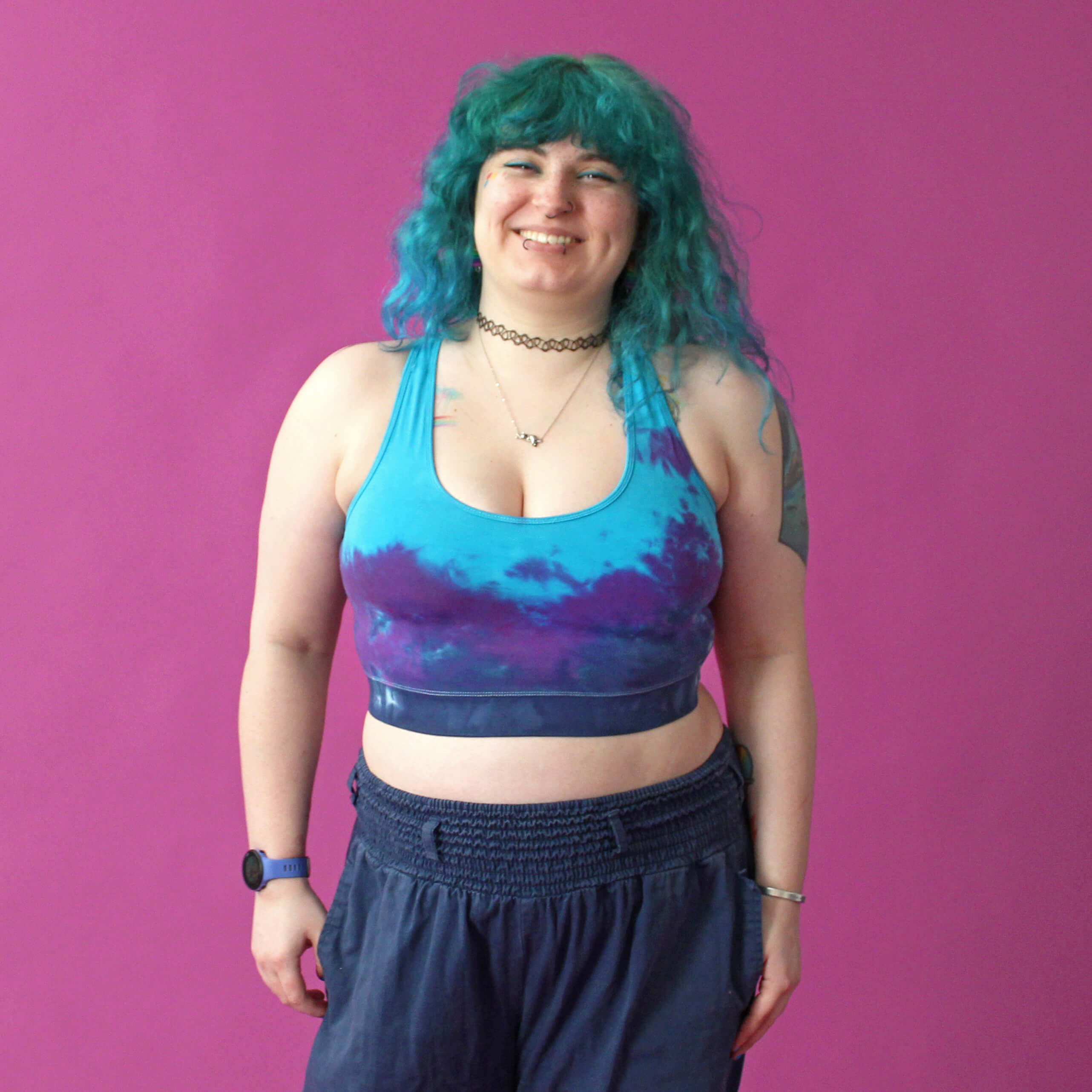 Taylor is wearing a purple and blue tie-dye longline bralette
