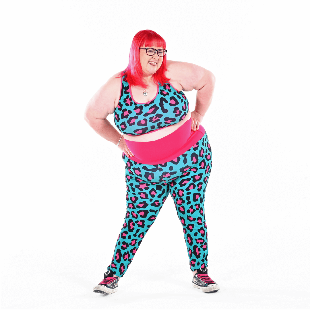 Rhona is wearing teal and pink leopard print leggings and bralette